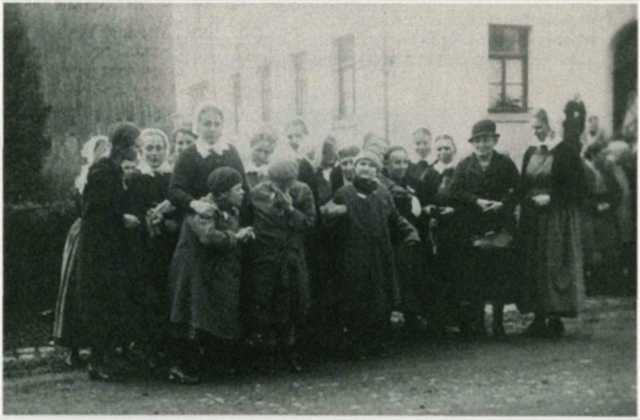 Group of girls and women standing on street.