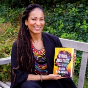 Ruha Benjamin holding her book, Viral Justice